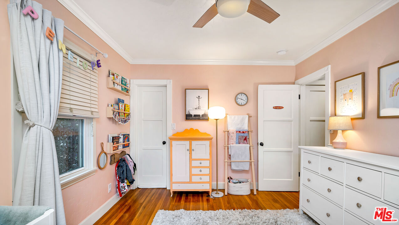 6557 Ruffner Avenue Lake Balboa, CA 91406 - Photo 14 of 31 a view of a bedroom with baby bed and workspace