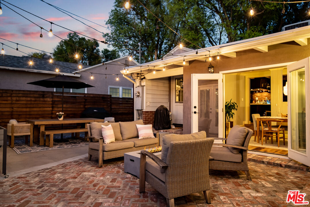 6557 Ruffner Avenue Lake Balboa, CA 91406 - Photo 28 of 31 a view of a patio with couches table and chairs and potted plants