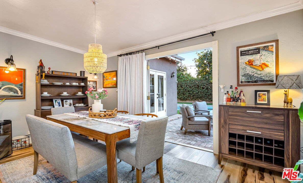 6557 Ruffner Avenue Lake Balboa, CA 91406 - Photo 7 of 31 a dining room with furniture a rug and a floor to ceiling window