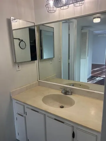 a bathroom with a sink and mirror