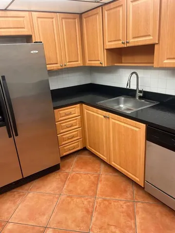 a white toilet sitting next to a shower