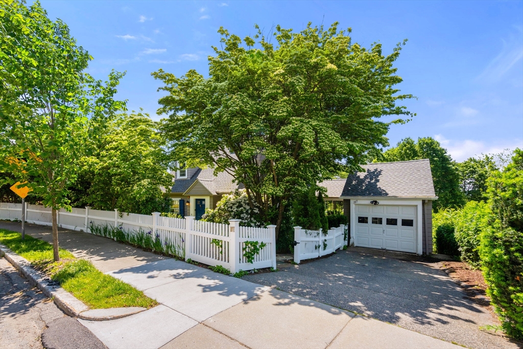107 Stoneleigh Road Watertown, MA 02472 - Photo 14 of 42 a view of a house with a yard and a large tree
