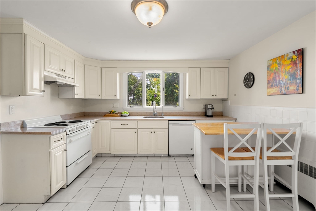 107 Stoneleigh Road Watertown, MA 02472 - Photo 18 of 42 a kitchen with a cabinets a sink and appliances in it