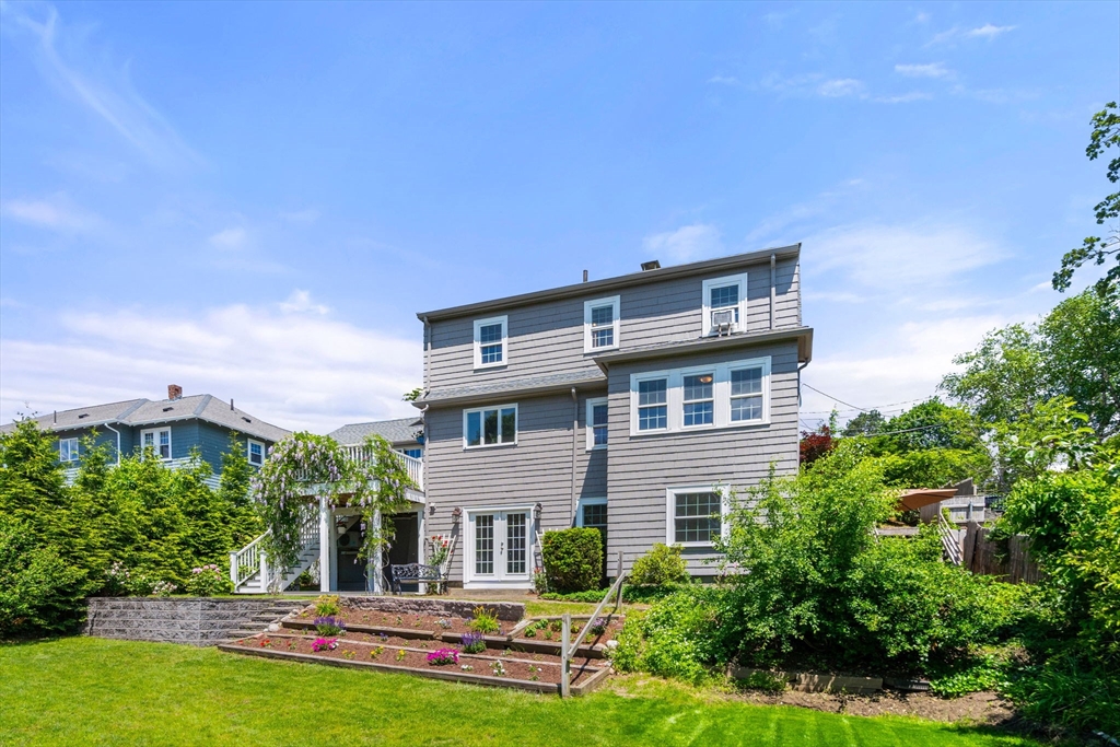 107 Stoneleigh Road Watertown, MA 02472 - Photo 2 of 42 a house view with swimming pool and garden space