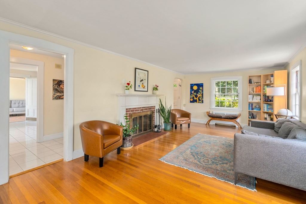 107 Stoneleigh Road Watertown, MA 02472 - Photo 23 of 42 a living room with furniture a fireplace and a large window