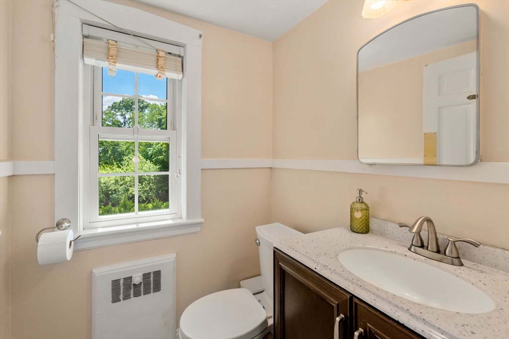 107 Stoneleigh Road Watertown, MA 02472 - Photo 25 of 42 a bathroom with a sink a toilet and a window