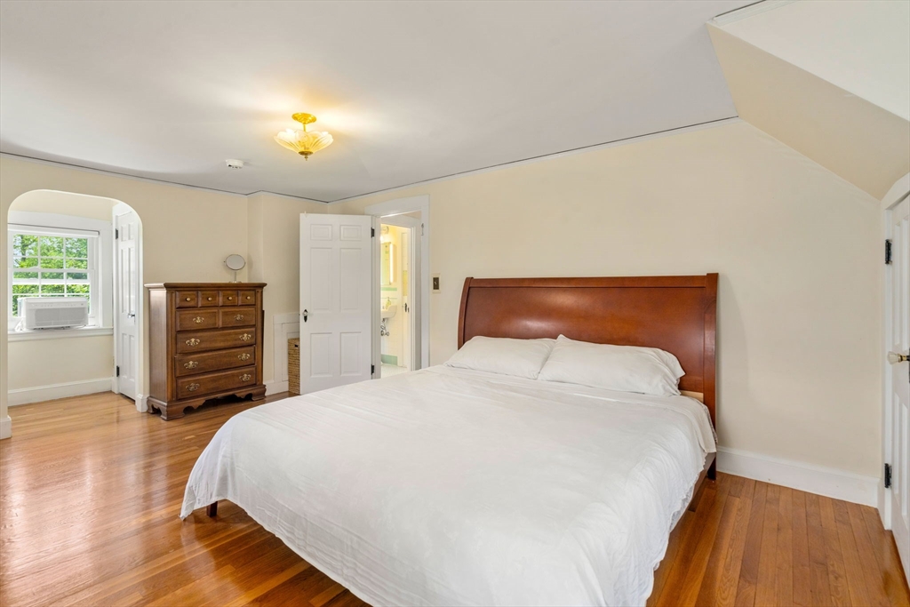 107 Stoneleigh Road Watertown, MA 02472 - Photo 27 of 42 a bedroom with a bed and a chair