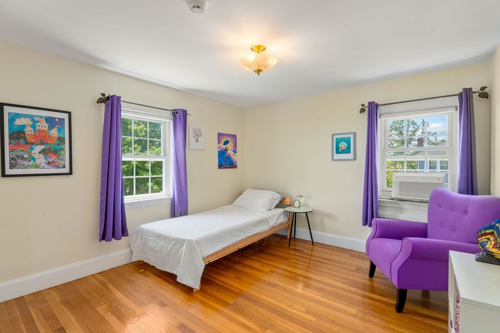 107 Stoneleigh Road Watertown, MA 02472 - Photo 30 of 42 a bedroom with a bed and wooden floor