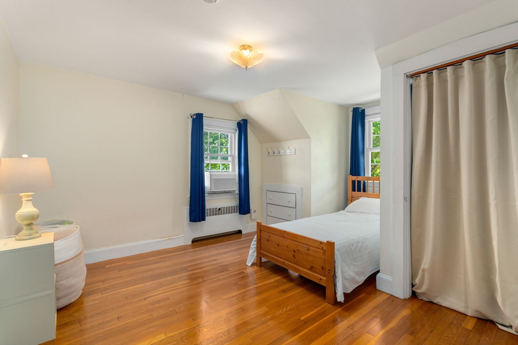 107 Stoneleigh Road Watertown, MA 02472 - Photo 31 of 42 a spacious bedroom with a bed and a lamp on desk
