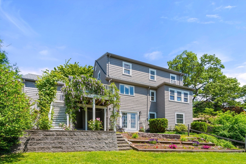 107 Stoneleigh Road Watertown, MA 02472 - Photo 4 of 42 a front view of a house with a yard