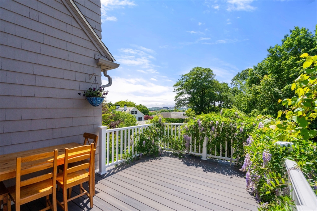 107 Stoneleigh Road Watertown, MA 02472 - Photo 6 of 42 a view of a balcony with wooden floor and fence