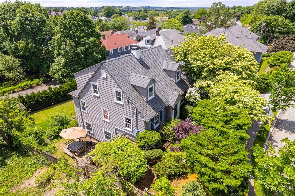 107 Stoneleigh Road Watertown, MA 02472 - Photo 9 of 42 an aerial view of a house with a yard and garden