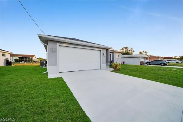 a front view of a house with a yard and garage