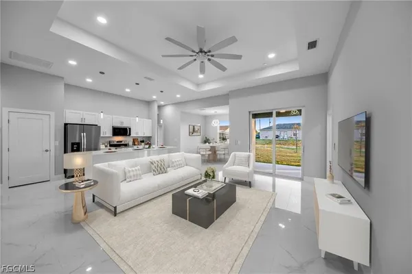 a living room with furniture and view of kitchen