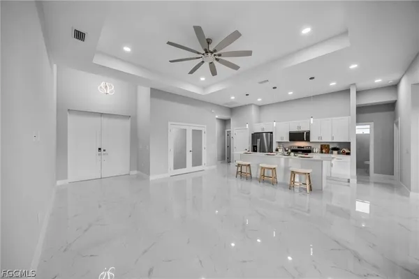 a kitchen with stainless steel appliances kitchen island granite countertop a dining table and chairs