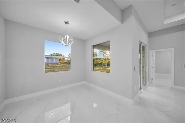 a kitchen with a sink a refrigerator and chairs