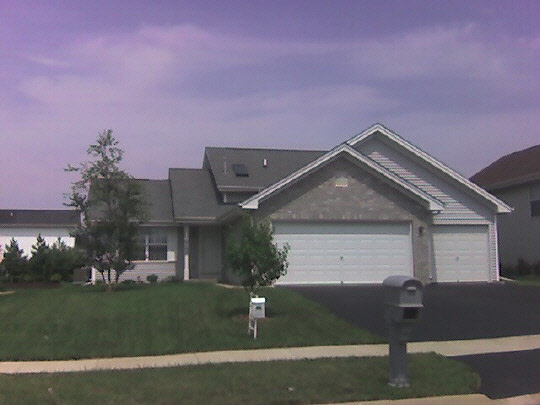 4192 Linden Road Rockford, IL 61109 - Photo 1 of 7 a front view of a house with a yard