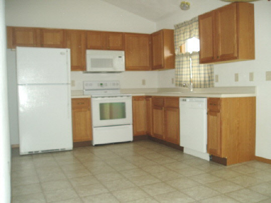 4192 Linden Road Rockford, IL 61109 - Photo 4 of 7 a kitchen with stainless steel appliances granite countertop a stove a sink and a refrigerator