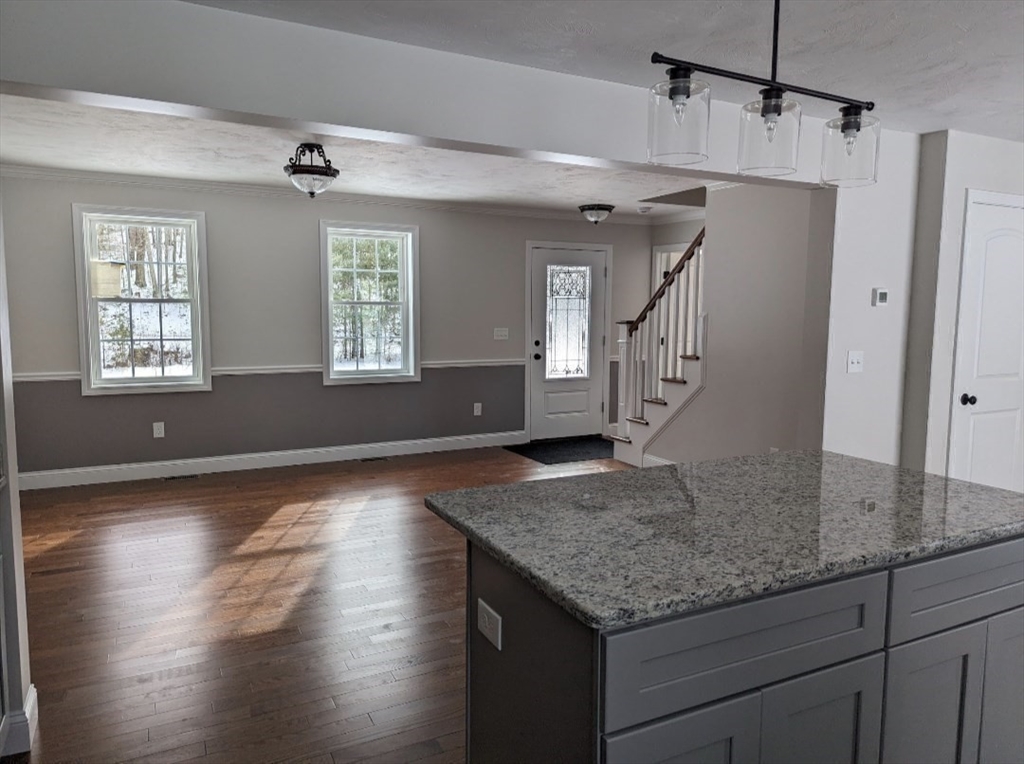 508 Old County Road Holland, MA 01521 - Photo 11 of 42 a kitchen with kitchen island granite countertop a sink window and refrigerator
