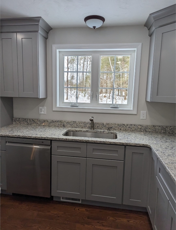 508 Old County Road Holland, MA 01521 - Photo 16 of 42 a kitchen with granite countertop wooden cabinets a sink and dishwasher next to a window