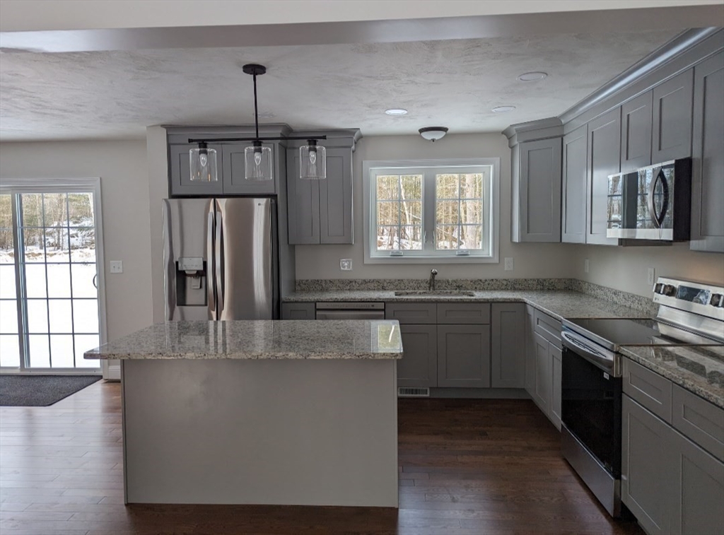 508 Old County Road Holland, MA 01521 - Photo 17 of 42 a kitchen with stainless steel appliances granite countertop a stove a sink and a refrigerator