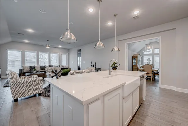 a large white kitchen with a large window