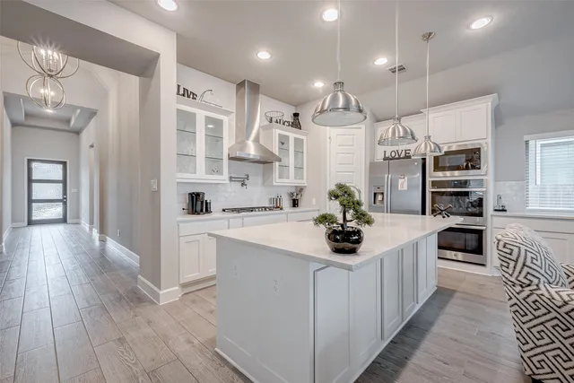 a kitchen with stainless steel appliances kitchen island granite countertop a sink and cabinets