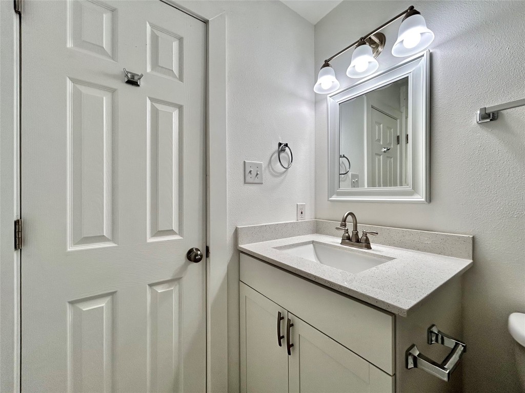6409 Burns Street, Unit 305 Austin, TX 78752 - Photo 16 of 19 a bathroom with a sink and a mirror
