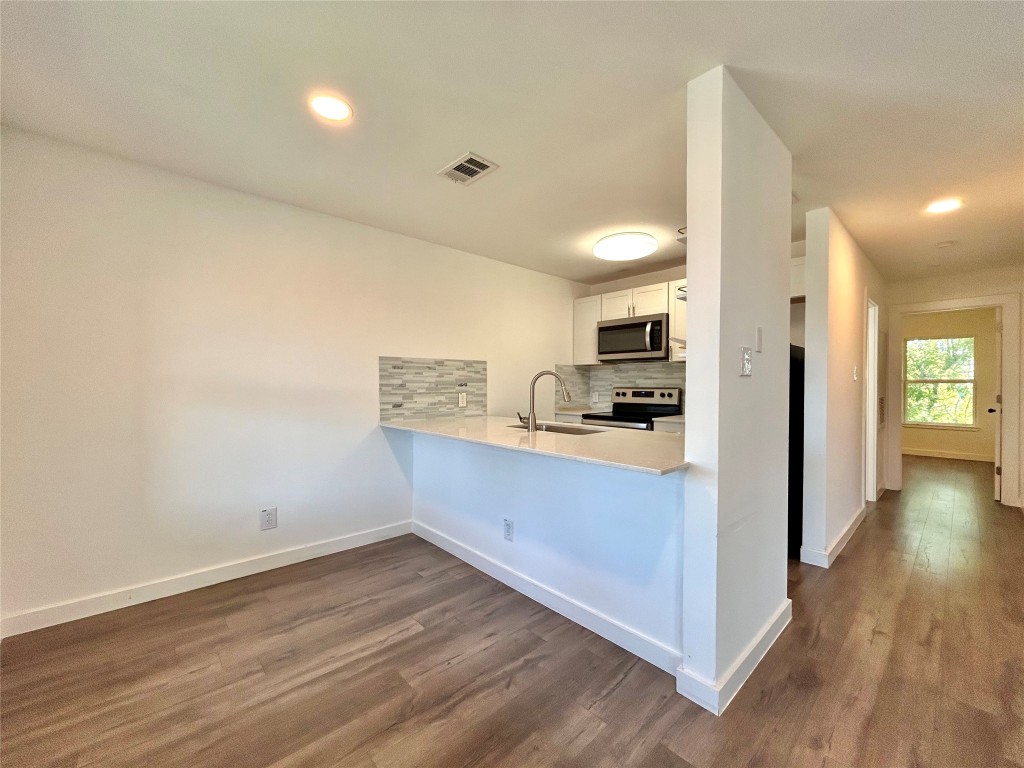 6409 Burns Street, Unit 305 Austin, TX 78752 - Photo 2 of 19 a view of kitchen with wooden floor