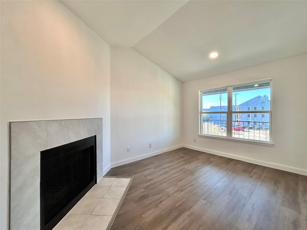 6409 Burns Street, Unit 305 Austin, TX 78752 - Photo 4 of 19 a view of an empty room with wooden floor and a window