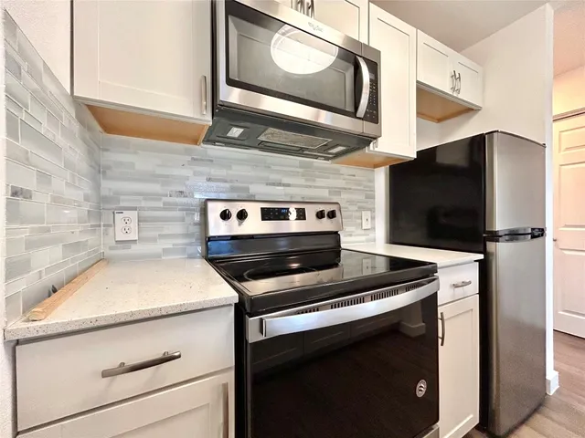 a kitchen with a stove and a microwave