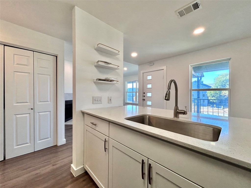 6409 Burns Street, Unit 305 Austin, TX 78752 - Photo 8 of 19 a close view of a sink and a refrigerator in a kitchen