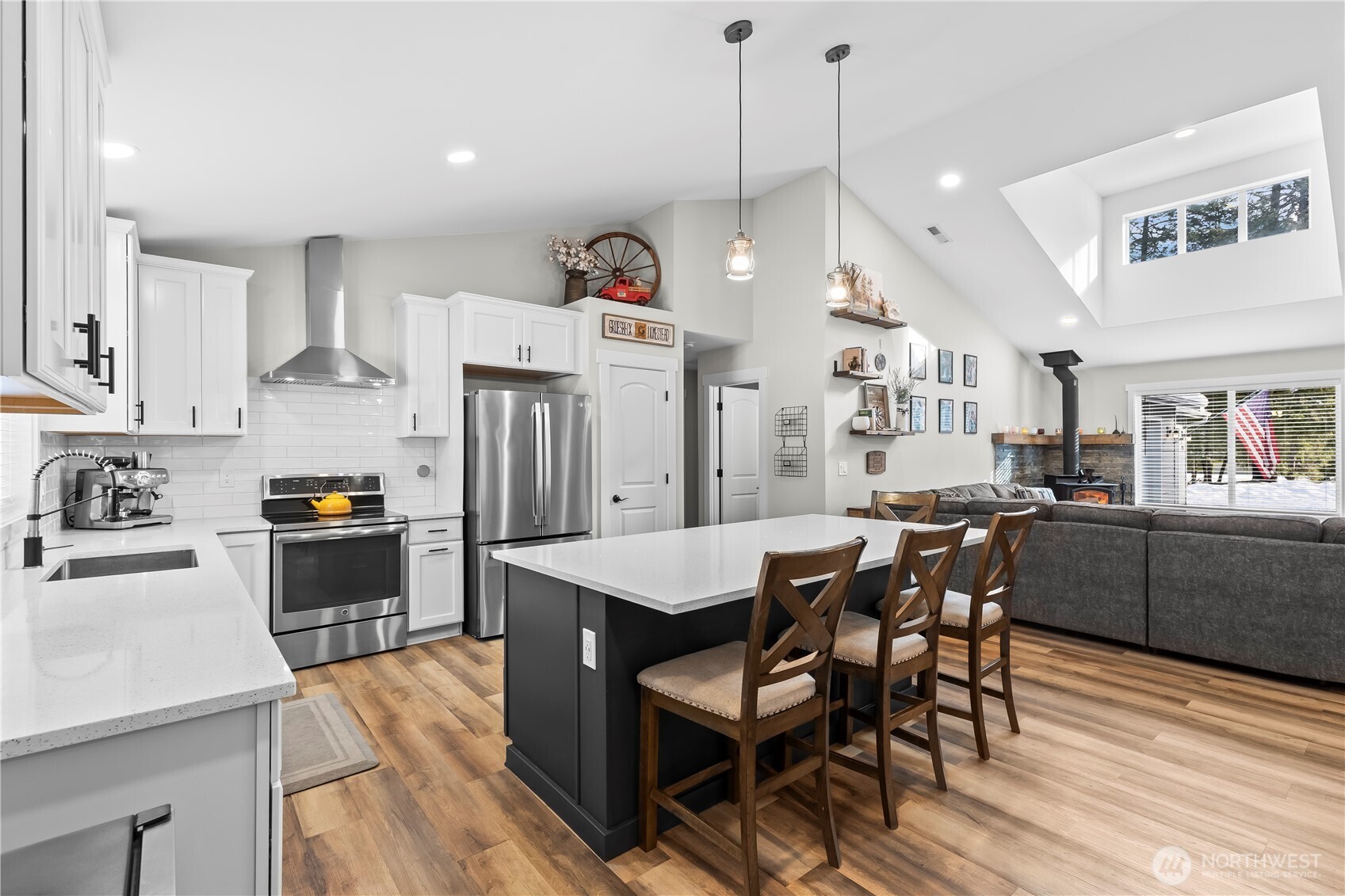 971 Old Cedars Road Cle Elum, WA 98922 - Photo 9 of 39 a kitchen with stainless steel appliances kitchen island granite countertop a table chairs and a refrigerator
