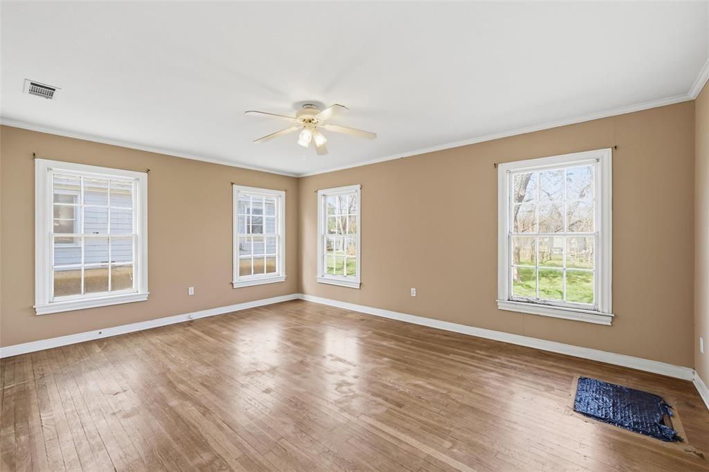 3005 Windsor Avenue Waco, TX 76708 - Photo 23 of 37 a view of an empty room with a window and wooden floor