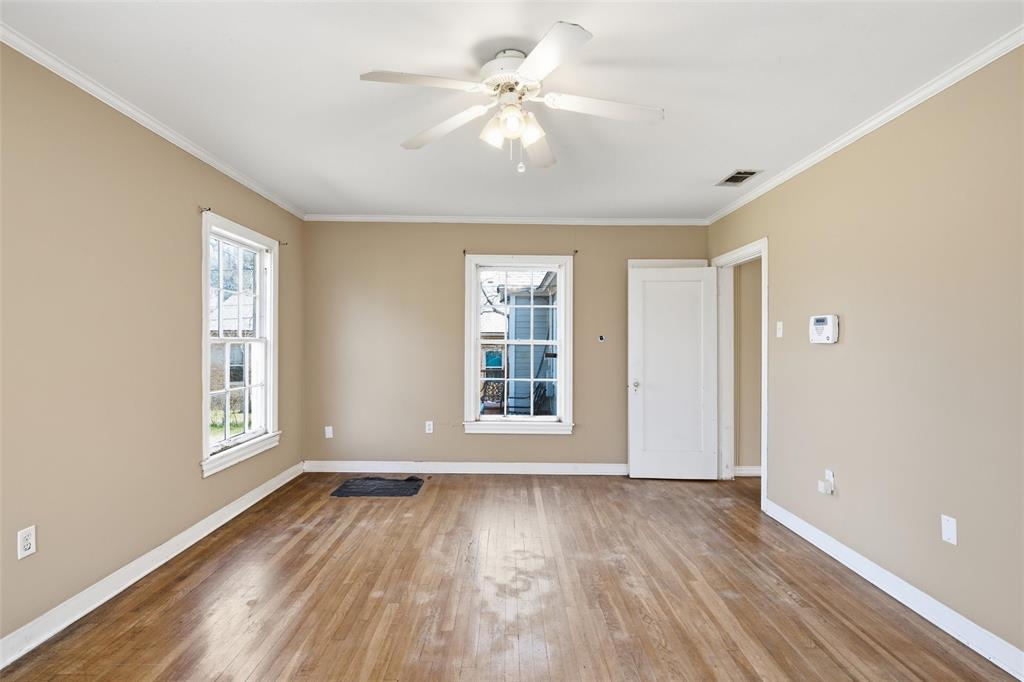 3005 Windsor Avenue Waco, TX 76708 - Photo 25 of 37 an empty room with wooden floor chandelier fan and windows