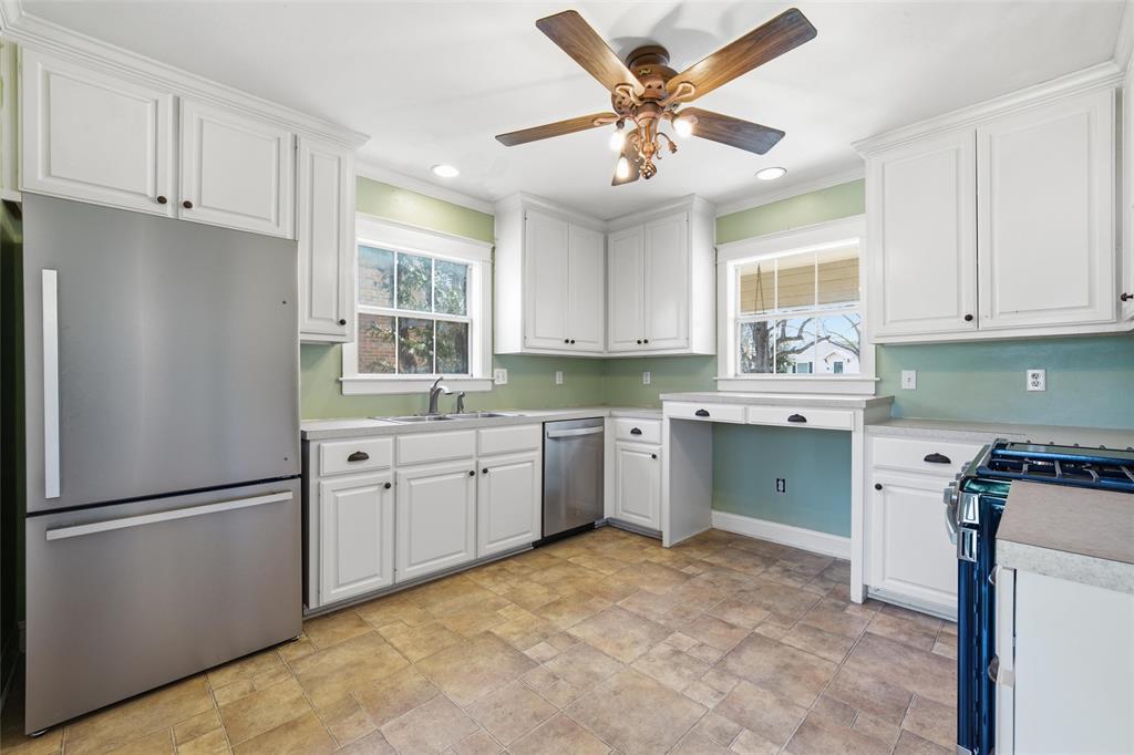 3005 Windsor Avenue Waco, TX 76708 - Photo 10 of 37 a kitchen with granite countertop a refrigerator cabinets stainless steel appliances and a window