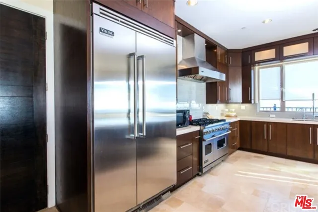 a kitchen with stainless steel appliances granite countertop a refrigerator a sink and dishwasher