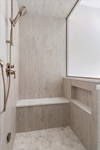 a white bath tub sitting next to a white toilet