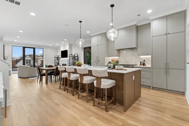 a kitchen with stainless steel appliances granite countertop a sink a stove and a refrigerator