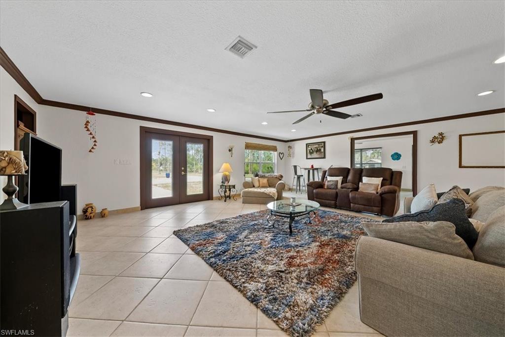 6070 Lee Williams Road Naples, FL 34117 - Photo 16 of 26 a living room with furniture rug and window