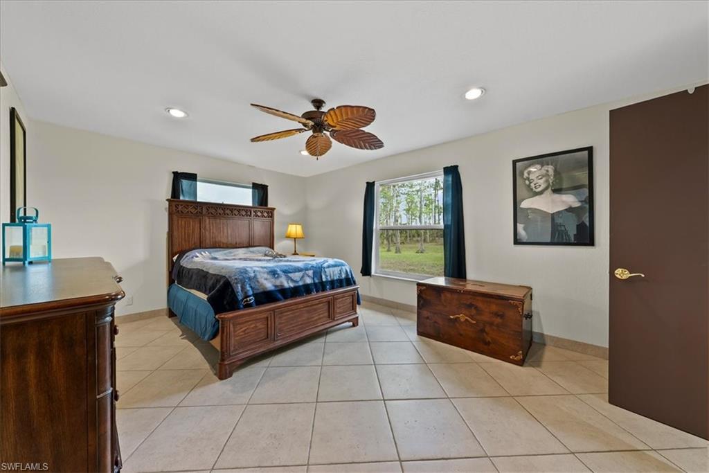 6070 Lee Williams Road Naples, FL 34117 - Photo 19 of 26 a bedroom with a bed and window