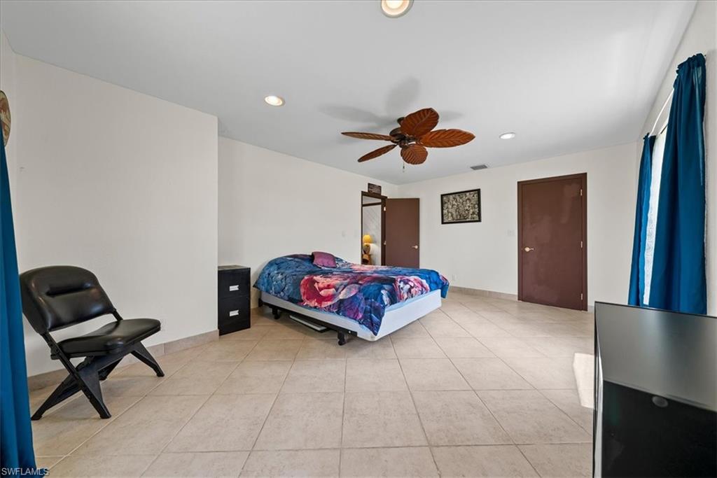 6070 Lee Williams Road Naples, FL 34117 - Photo 21 of 26 a living room with furniture and a window