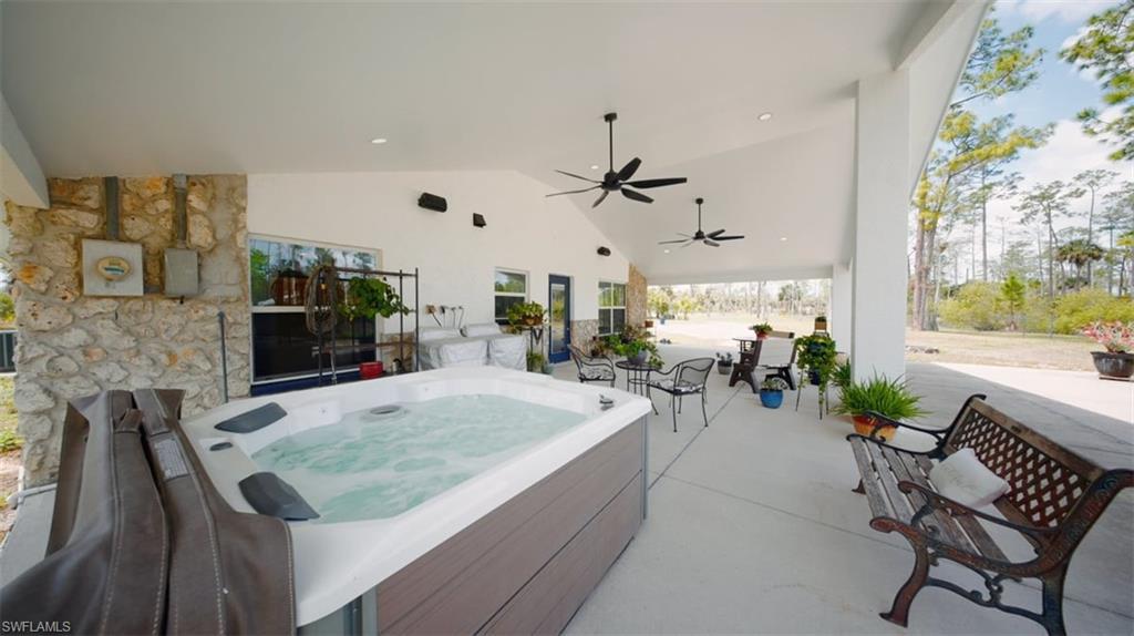 6070 Lee Williams Road Naples, FL 34117 - Photo 23 of 26 a living room with furniture and a large window