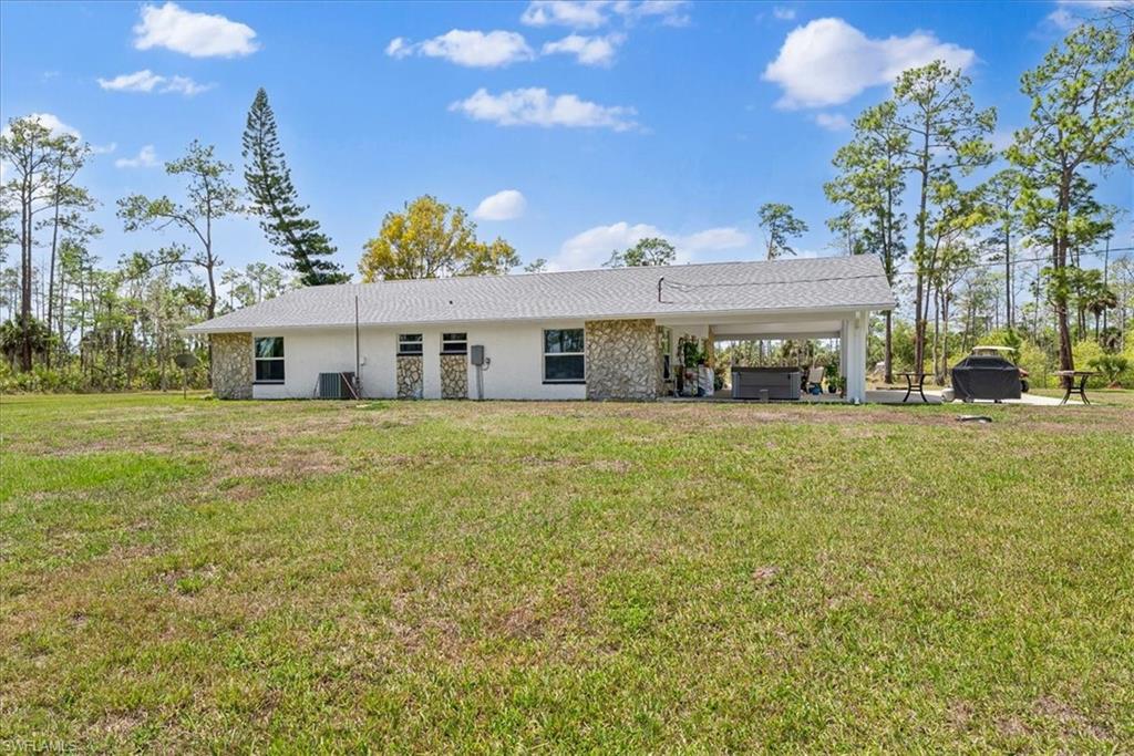 6070 Lee Williams Road Naples, FL 34117 - Photo 24 of 26 a view of a house with a big yard