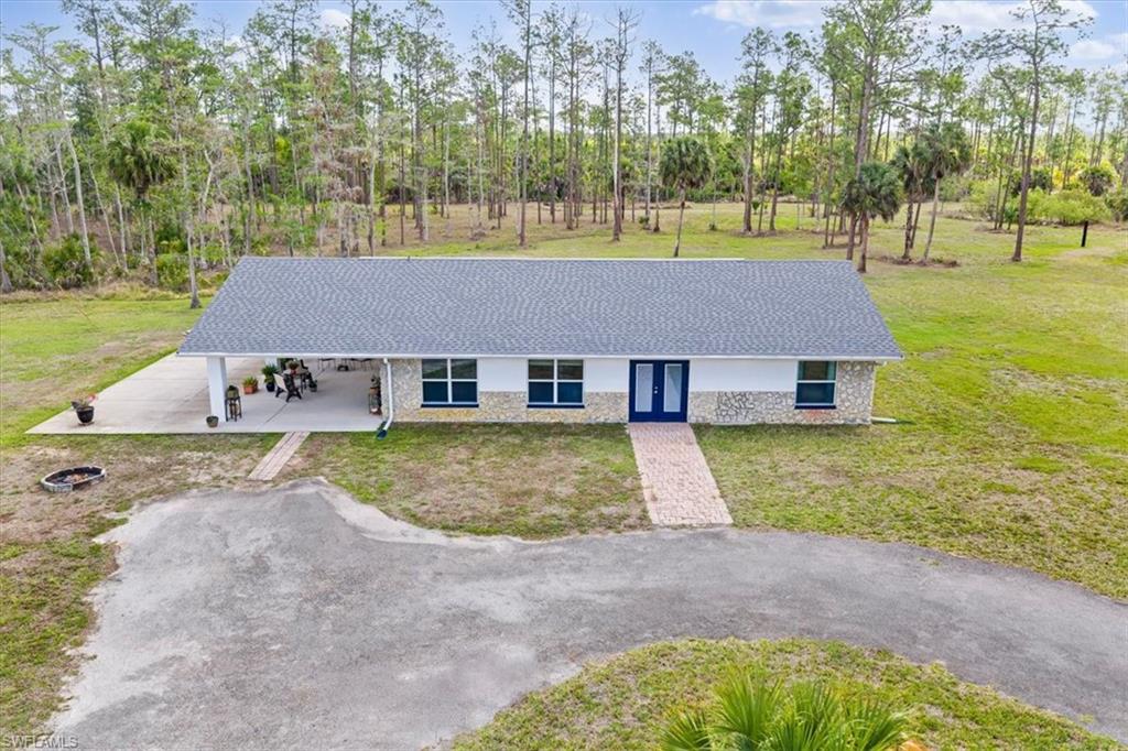 6070 Lee Williams Road Naples, FL 34117 - Photo 5 of 26 front view of house with a swimming pool