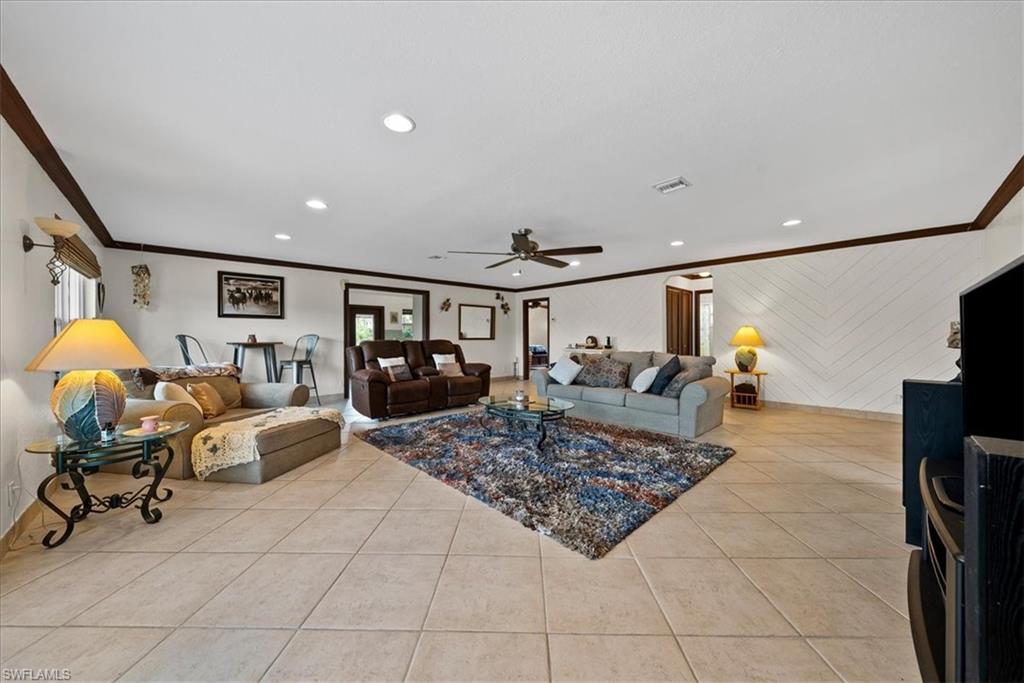 6070 Lee Williams Road Naples, FL 34117 - Photo 8 of 26 a living room with furniture and a table