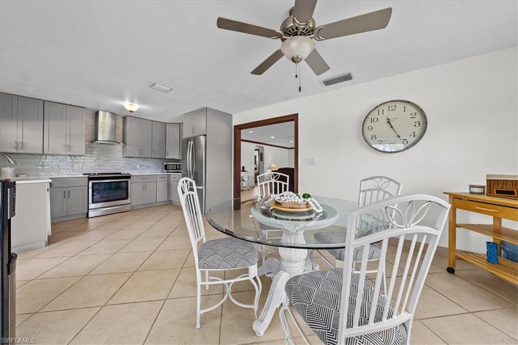 6070 Lee Williams Road Naples, FL 34117 - Photo 9 of 26 a view of a dining room with furniture