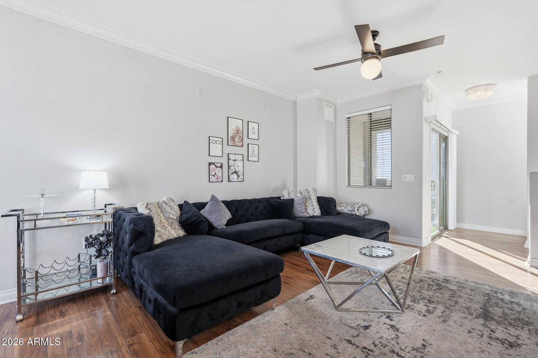 2402 East 5th Street, Unit 1409 Tempe, AZ 85288 - Photo 1 of 34 a living room with furniture and a wooden floor