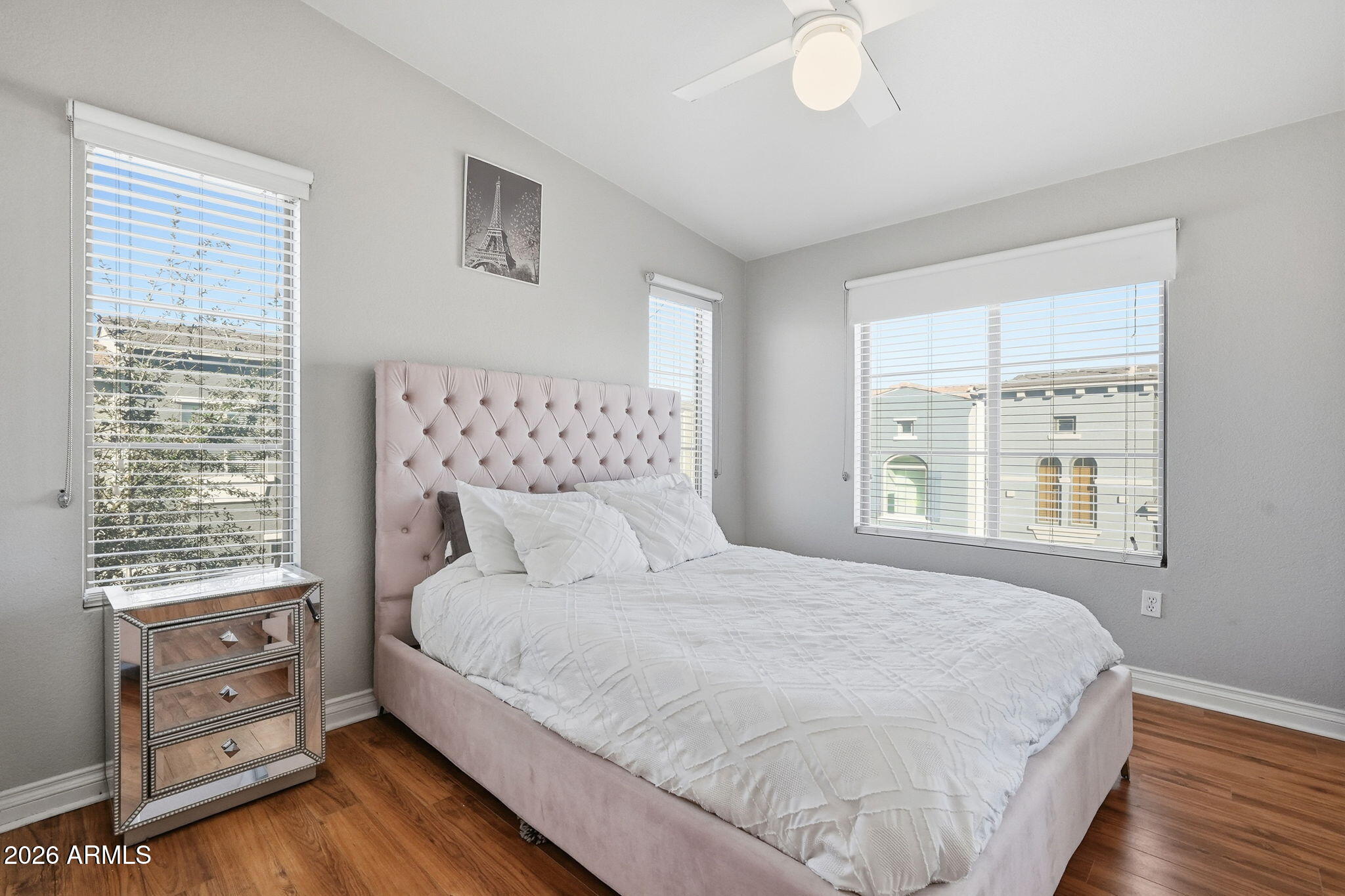 2402 East 5th Street, Unit 1409 Tempe, AZ 85288 - Photo 13 of 34 a large bed sitting in a bedroom next to a window