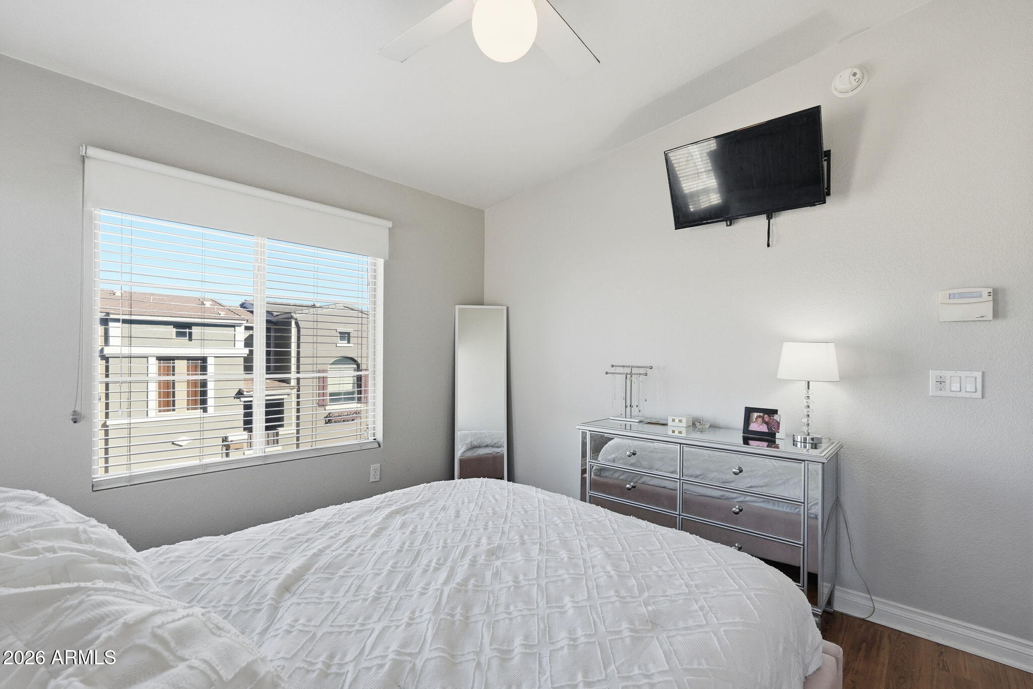 2402 East 5th Street, Unit 1409 Tempe, AZ 85288 - Photo 14 of 34 a bedroom with a bed and a flat screen tv